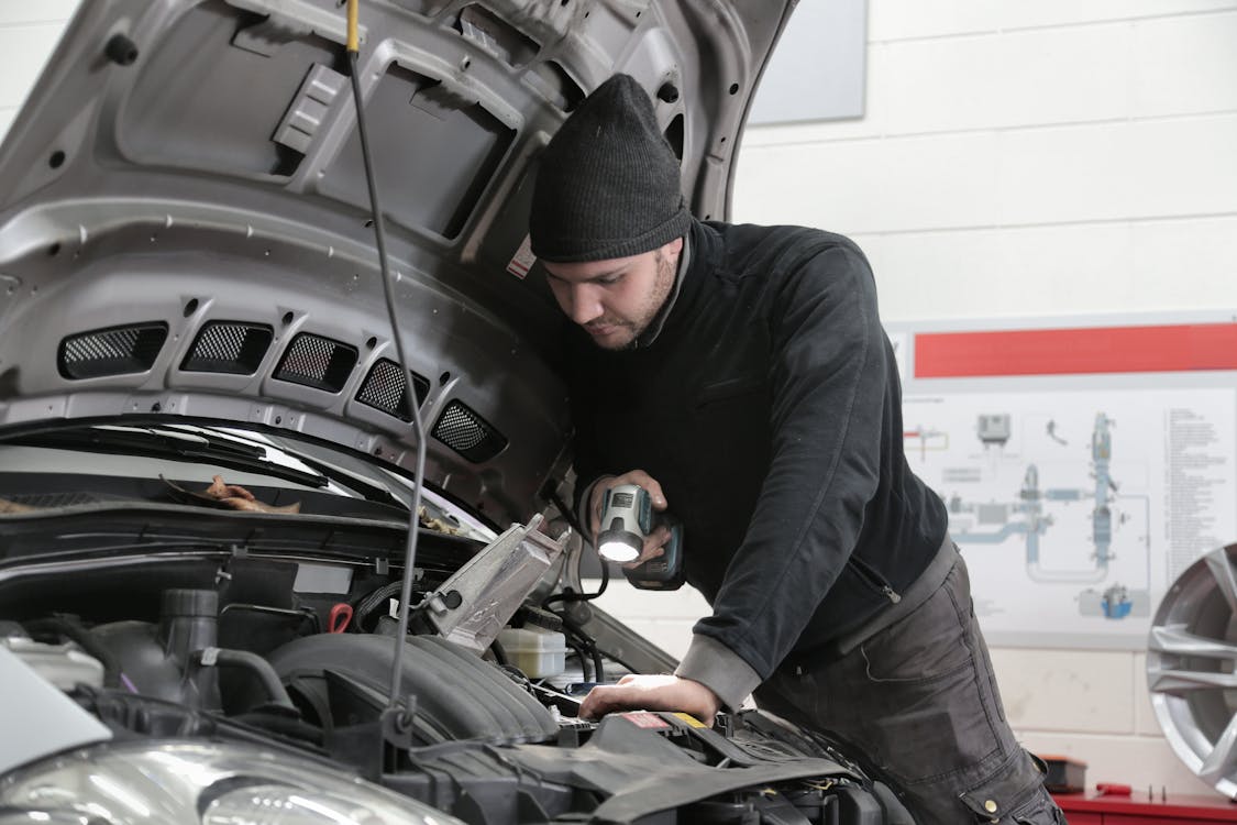 Open car hood during a budget-friendly mobile mechanic repair in the Oklahoma City metro