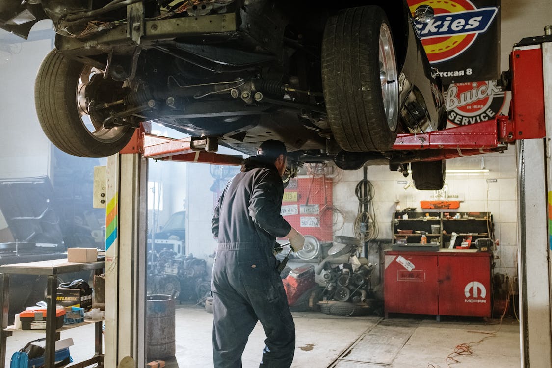 ASE certified mechanic standing beside a vehicle ready to perform on-site auto repair