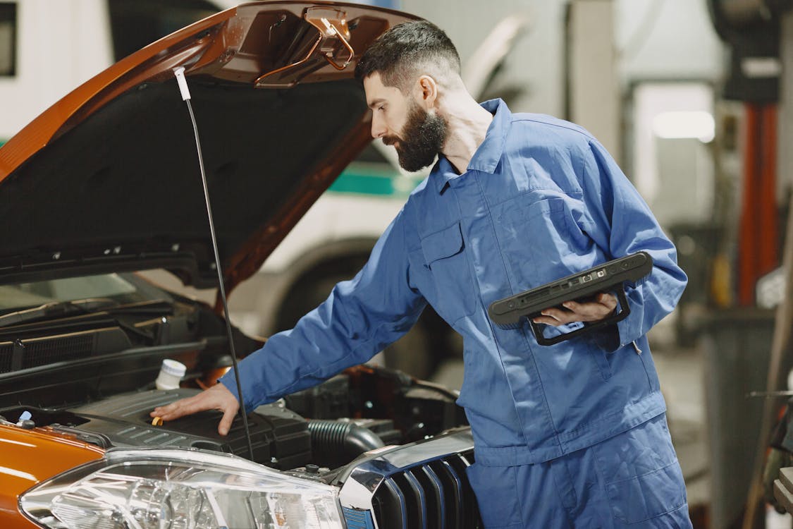 Mechanic checking engine during a mobile car service appointment in Oklahoma City