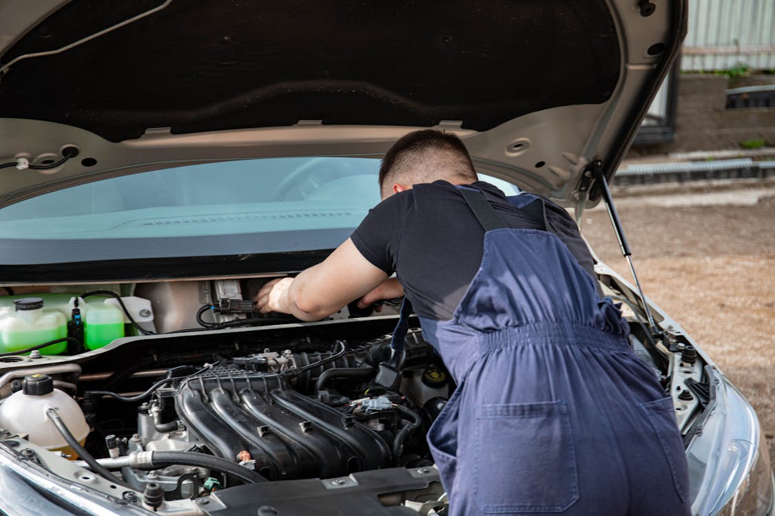 Mobile mechanic fixing a car part at an affordable price in Oklahoma City