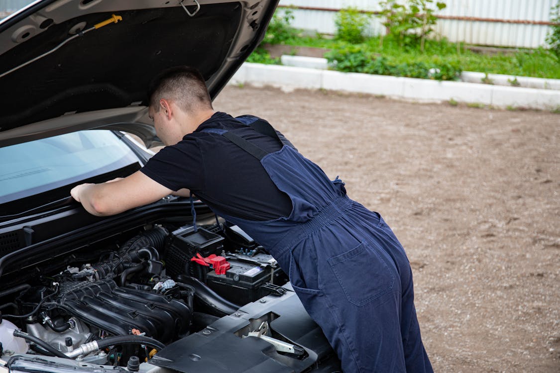 ASE certified mechanic performing car repair on engine components in Oklahoma City