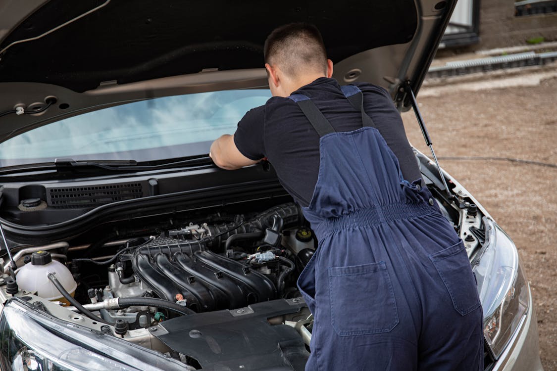 ASE certified mechanic performing mobile auto repair on a vehicle engine in Oklahoma City